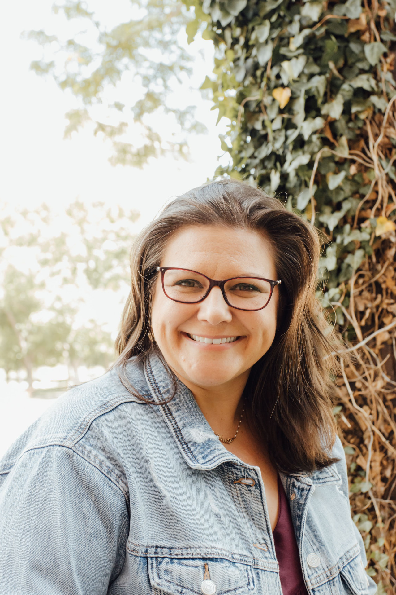 Christy, licensed counselor at Flourish Mental Health Counseling, smiling outdoors